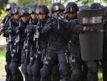 Note shields, weapon mounted lights, and matching uniforms...a few indicators of a SWAT raid