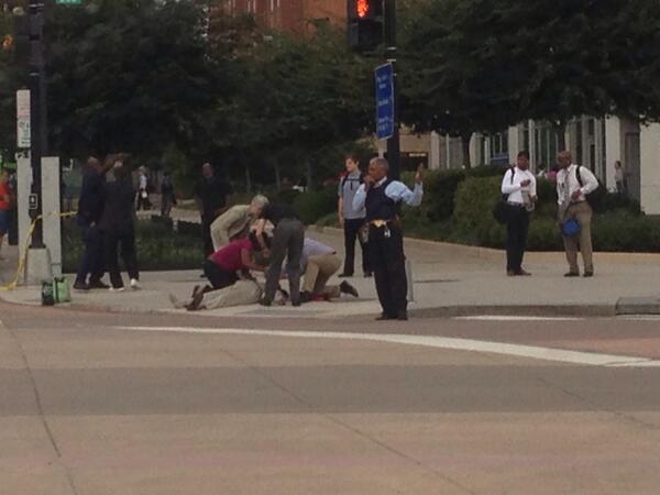 Injured person being treated on the sidewalk outside the building