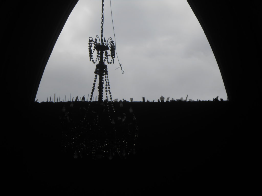 Broken glass embedded into the frame of a church window to deter thieves.