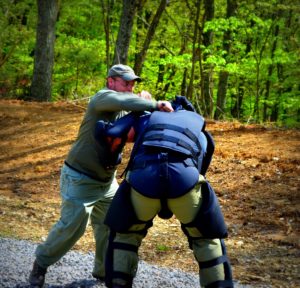 Student uses a mini-baton in a fight against a simulated attacker.