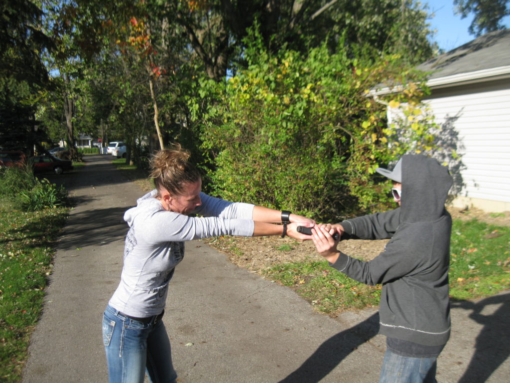 Turning the gun hand palm up, loosens the attacker's grip and gives you better range of motion for the upcoming pull