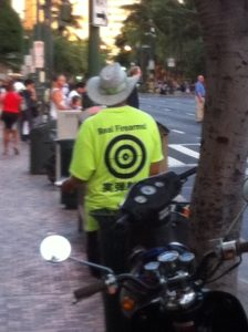 Man on a Honolulu street handing out gun range flyers