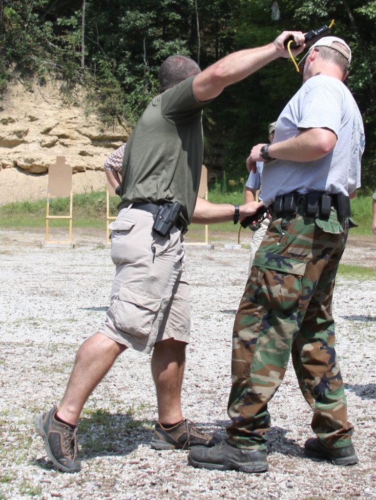 Teaching pistol whipping at a close quarters shooting class
