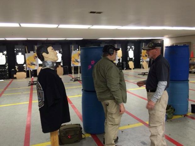 Dave briefing a student before the "robot" drill. Robot on left. From Handgun Combatives Facebook Page.