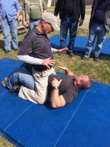 Showing some of the problems involved with shooting the snub from a grounded position as Dave Spaulding beats me up. Image stolen from Dave's Facebook Page.