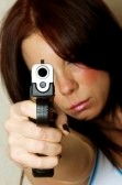 8281163-close-up-image-of-young-attractive-female-pointing-gun-focus-is-on-barrel-of-gun