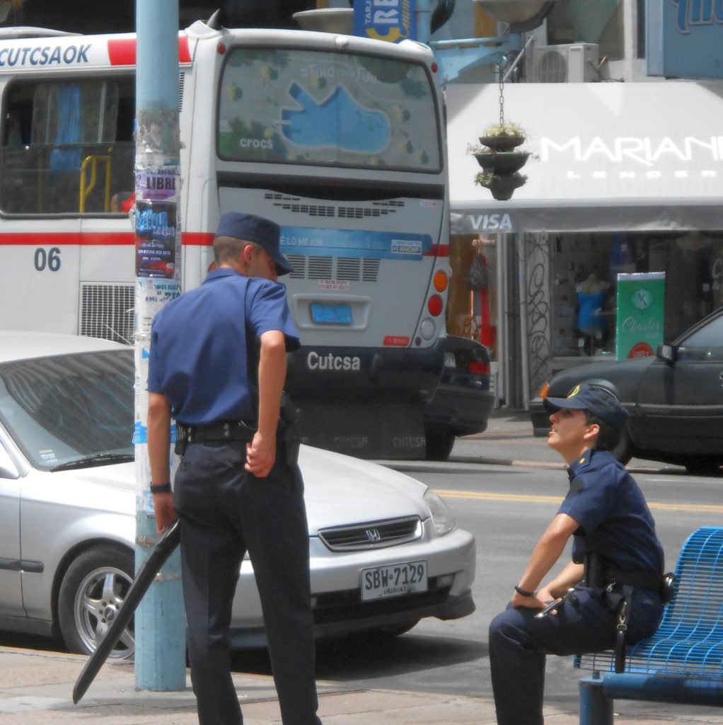 Uruguayan cop patrolling with cased long gun.